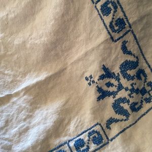 Cross stitched table cloth..  beige with blue stitch..52” x 72”